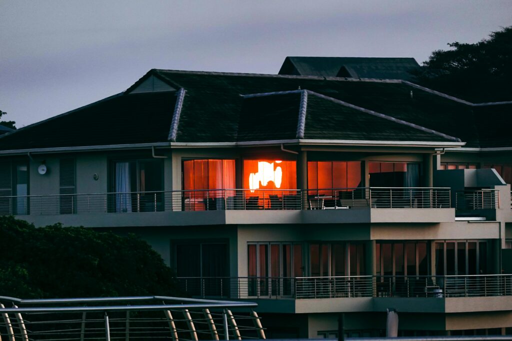 Elegant modern house on Dolphin Coast, South Africa, reflecting the warm glow of the sunset.