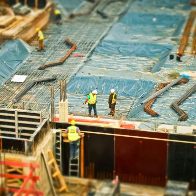 High-angle view of construction workers on a building site, engaging in construction work.