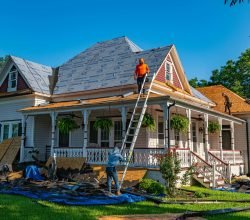 Roofers replace the roof of a historic home in Weatherford, Texas.